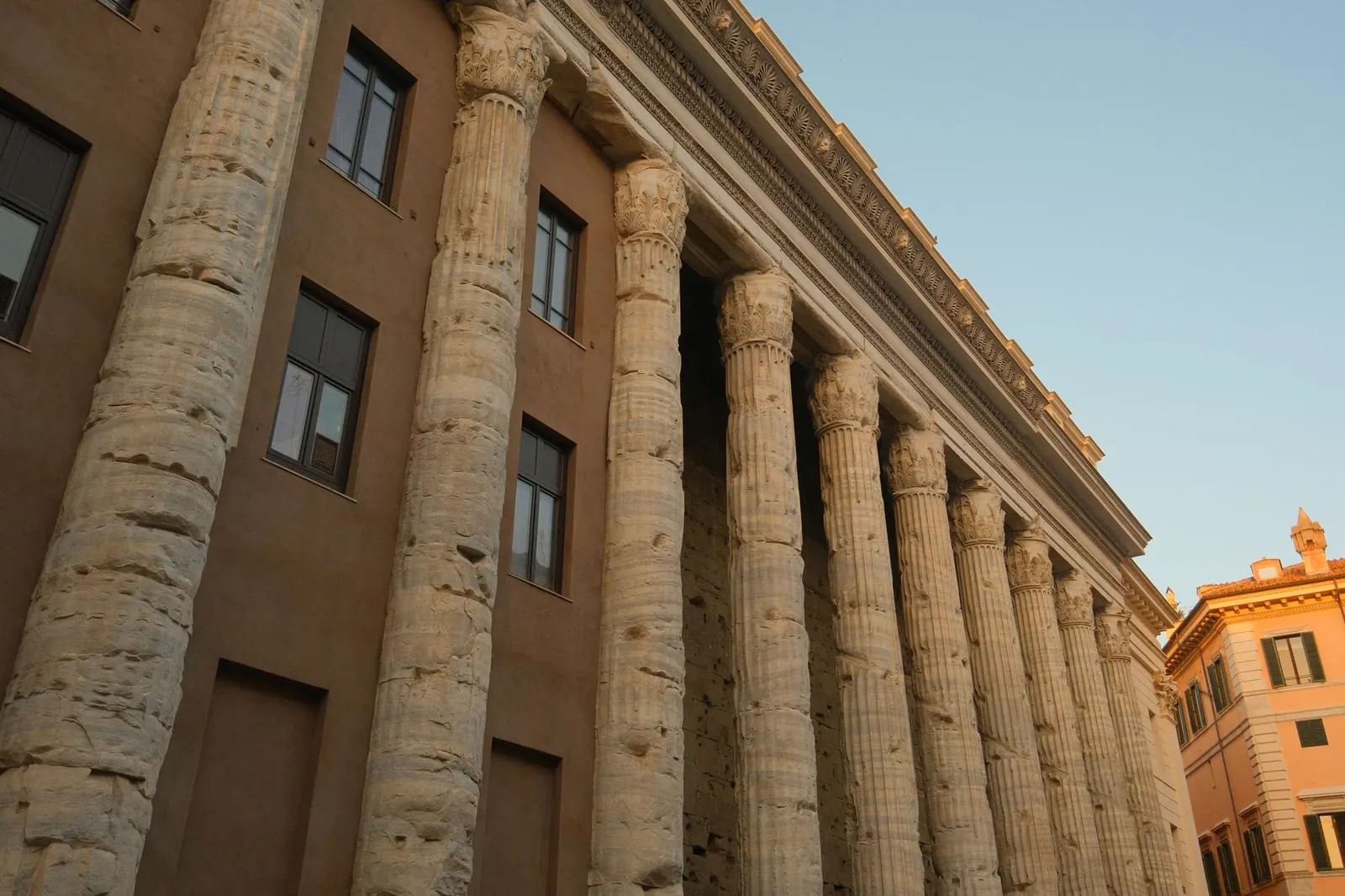 Close-up of ancient Corinthian columns from a Roman temple in Rome, Italy.
